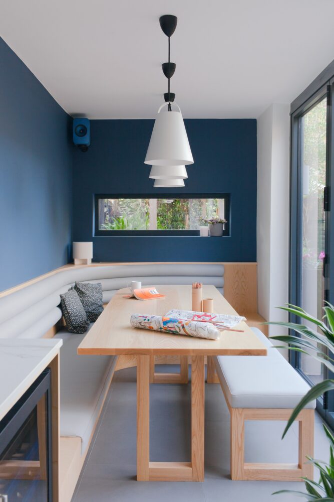 dining-table_dining-bench_banquette_picture-window_bi-fold-doors_blue-walls_tiled-floor_grey-tiles_vegan-leather